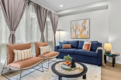 a living room with a blue couch and two chairs at ML4- Private Rooftop Hot Tub Oasis- Entire townhouse with MTN View in Canmore