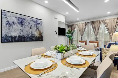 a dining room with a white table and chairs at ML4- Private Rooftop Hot Tub Oasis- Entire townhouse with MTN View in Canmore