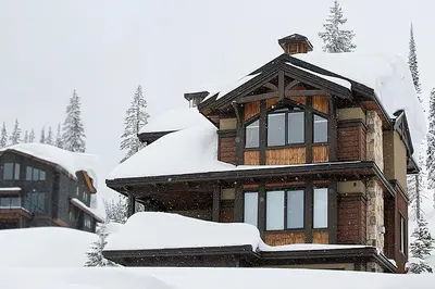 a house covered in snow at Dwight Out Chalet with Hot Tub in Big White