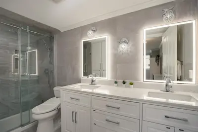 a bathroom with two sinks and a toilet and a shower at 2BR in Nicklaus North Clubhouse, Lake and Mountain Views, Gas Fireplace, Parking in Whistler