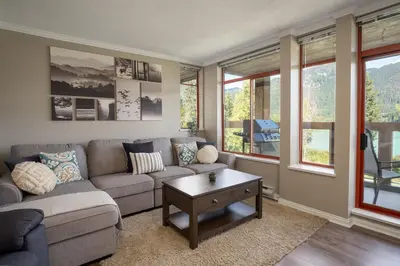 a living room with a couch and a coffee table at 2BR in Nicklaus North Clubhouse, Lake and Mountain Views, Gas Fireplace, Parking in Whistler