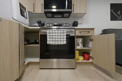 a kitchen with an oven and a microwave at Modern Suite by Royal Alexandra Hospital l Free Parking WiFi Netflix in Edmonton