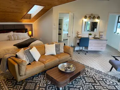 a living room with a couch and a bed at Tyee Beach Oasis Bed and Breakfast in Nanoose Bay