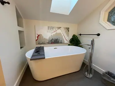 a large white bath tub in a bathroom at Tyee Beach Oasis Bed and Breakfast in Nanoose Bay