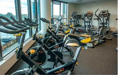 a row of exercise bikes lined up in a gym at Urban Oasis - Comfort & Luxury in Calgary