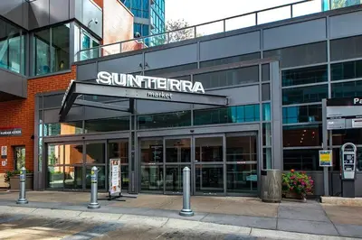 a suntera building with a sign on the front of it at Urban Oasis - Comfort & Luxury in Calgary