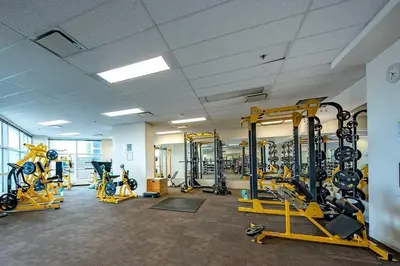 a gym with a lot of treadmills and machines at Urban Oasis - Comfort & Luxury in Calgary