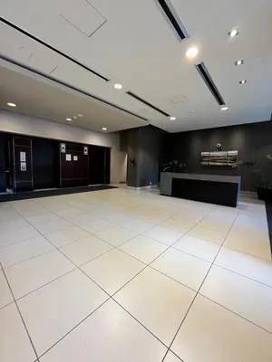 a large room with a large white tile floor and a table at Urban Oasis - Comfort & Luxury in Calgary