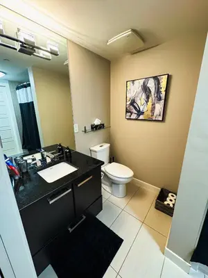 a bathroom with a sink and a toilet in it at Urban Oasis - Comfort & Luxury in Calgary