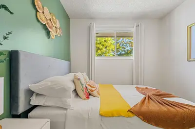 a bedroom with a bed and a window at Digital Nomad's Calgary Inner City Gem 3Bd, 5Bed, Sleeps 8, Main Level in Calgary