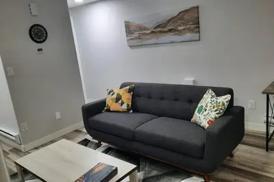 a living room with a couch and a table at Carsonway Basement Suite in Edmonton