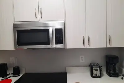 a kitchen with a microwave above a counter at Carsonway Basement Suite in Edmonton