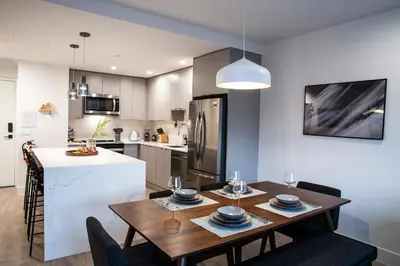 a kitchen and dining room with a table and chairs at Cedar and Loam by Revelstoke Vacations in Revelstoke