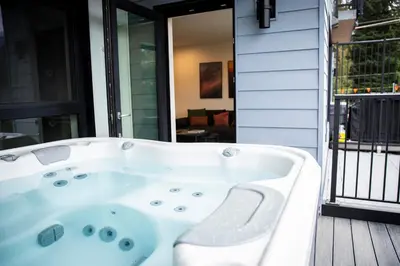 a white bath tub sitting on a porch at Cedar and Loam by Revelstoke Vacations in Revelstoke