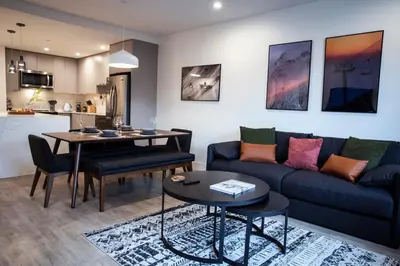 a living room with a couch and a table at Cedar and Loam by Revelstoke Vacations in Revelstoke