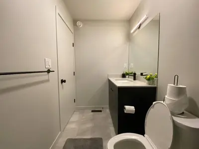 a white bathroom with a toilet and a sink at ZierHomes in Devon