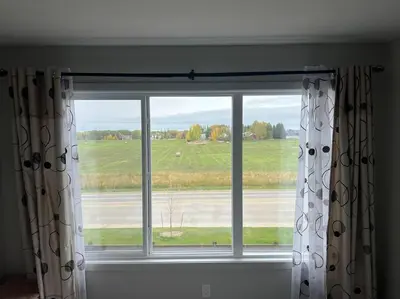 a window with a view of a field at ZierHomes in Devon