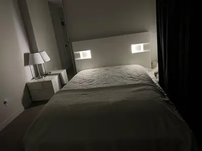 a bedroom with a large bed with two night stands at ZierHomes in Devon