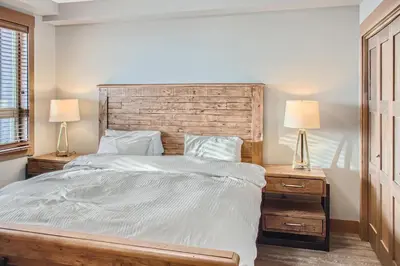 a bedroom with a large bed with two night stands at Stonegate Resort Unit B302 in Big White