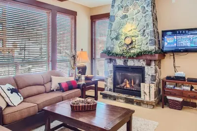 a living room with a couch and a fireplace at Stonegate Resort Unit C402 in Big White