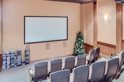 a conference room with a blank screen and a christmas tree at Stonegate Resort Unit C402 in Big White