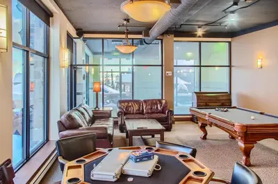 a living room with a pool table at Stonegate Resort Unit C402 in Big White