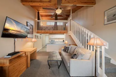 a living room with a couch and a table at Shorewater Resort, Qualicum Beach in Qualicum Beach