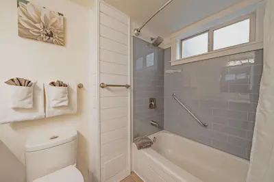 a bathroom with a tub and a toilet and a shower at Shorewater Resort, Qualicum Beach in Qualicum Beach