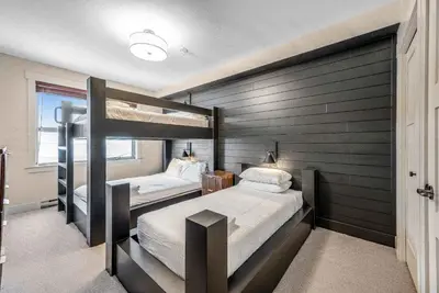 a bedroom with two bunk beds in it at Stonegate Resort Unit C106 in Big White