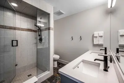 a bathroom with a shower and a sink and a toilet at Stonegate Resort Unit C106 in Big White
