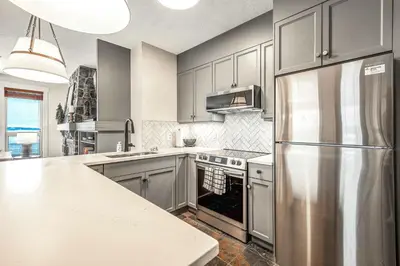 a kitchen with a stainless steel refrigerator at Stonegate Resort Unit C106 in Big White