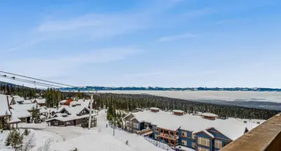 an aerial view of a ski resort with snow covered roofs at Stonegate Resort Unit C106 in Big White