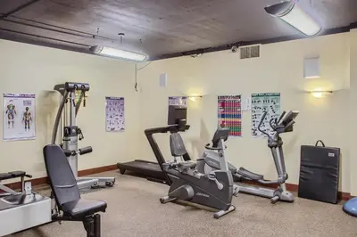a gym with several treadmills and exercise bikes at Stonegate Resort Unit A202 in Big White