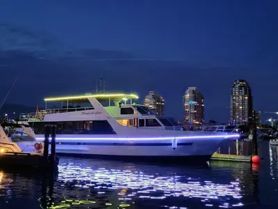 a large boat is docked in the water at night at Shangri-la Cheer in Vancouver