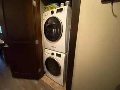 a washer and dryer in a room at Stylish Family Condo at Beachfront Resort in Parksville