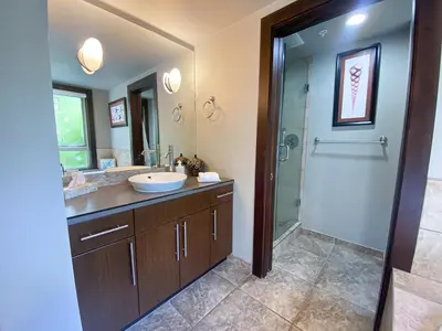 a bathroom with a sink and a shower at Stylish Family Condo at Beachfront Resort in Parksville