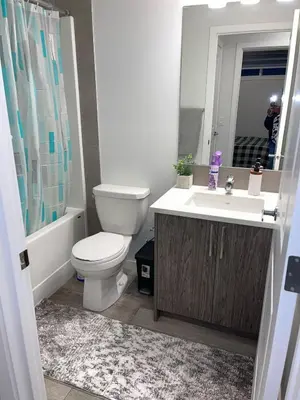 a bathroom with a toilet and a sink at Exquisite Basement Suite, 7mins away to Landmark Cinema and Malls in Calgary