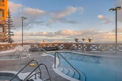 a swimming pool with snow on top of a building at Stonegate Resort Unit B107 in Big White