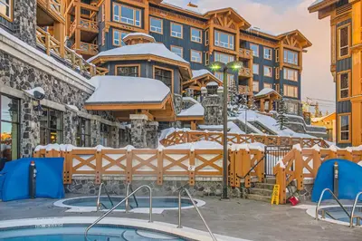 a resort with a pool in the snow at Stonegate Resort Unit B401 in Big White
