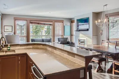 a kitchen and dining room with a large counter top at Stonegate Resort Unit B204 in Big White