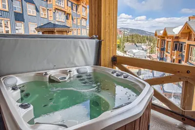a bath tub sitting on top of a balcony at Stonegate Resort Unit B208 in Big White