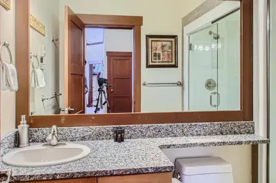 a bathroom with a sink and a large mirror at Stonegate Resort Unit A401 in Big White
