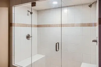 a shower stall with a glass shower door at Stonegate Resort Unit C304 in Big White