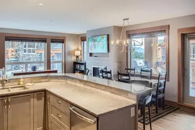 a kitchen and dining room with a large island at Stonegate Resort Unit B108 in Big White