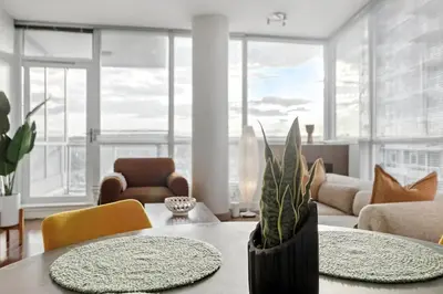 a living room with a table and a couch at Elevated Elegance in Calgary