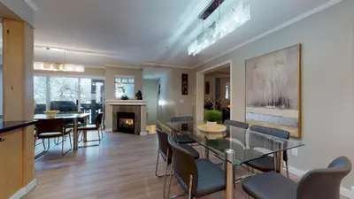 a living room with a glass table and chairs at LAGOONS 20 Village location Rare 5BDR Condo With Private Hot Tub in Whistler
