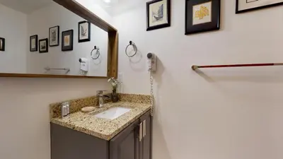 a bathroom with a sink and a mirror at LAGOONS 20 Village location Rare 5BDR Condo With Private Hot Tub in Whistler