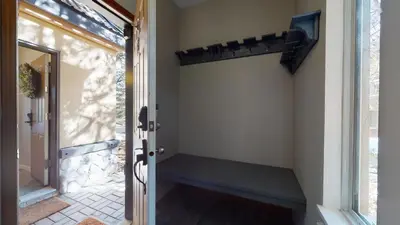 a door to a porch with a bench next to it at LAGOONS 20 Village location Rare 5BDR Condo With Private Hot Tub in Whistler