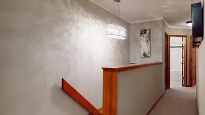a hallway of a house with a stairway at LAGOONS 20 Village location Rare 5BDR Condo With Private Hot Tub in Whistler