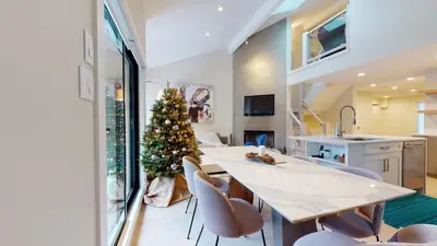 a kitchen with a christmas tree on a table at TELEMARK 25 Ski-In Ski-Out Access Steps To Ski Lifts Renovated Townhome in Whistler